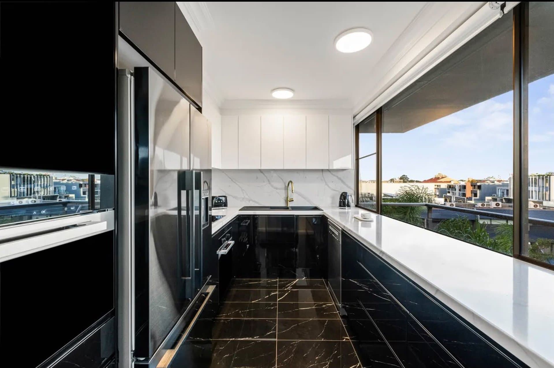 Sydney kitchen renovation with black joinery and marble benches
